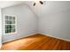 Vaulted ceiling bedroom featuring hardwood floors and a large window at 1583 Rogers Crossing Dr, Lithonia, GA 30058