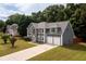 A charming two-story home with a stone facade and well-manicured lawn, nestled among mature trees at 1583 Rogers Crossing Dr, Lithonia, GA 30058
