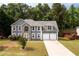 A charming two-story home with a stone facade, set on a well-manicured lawn with mature trees at 1583 Rogers Crossing Dr, Lithonia, GA 30058