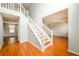 Bright foyer with wood flooring, staircase, and views into the adjacent living area at 1583 Rogers Crossing Dr, Lithonia, GA 30058