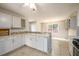 Updated kitchen with white cabinetry, breakfast bar, and stainless steel appliances at 1583 Rogers Crossing Dr, Lithonia, GA 30058