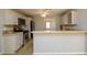 Charming kitchen with stainless steel appliances, light colored cabinetry and breakfast bar area at 1583 Rogers Crossing Dr, Lithonia, GA 30058