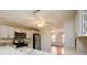 Bright kitchen with stainless appliances and white cabinets, connected to living area at 1583 Rogers Crossing Dr, Lithonia, GA 30058