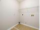 Functional laundry room with tile flooring and overhead wire shelving at 1583 Rogers Crossing Dr, Lithonia, GA 30058