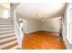 Spacious living room featuring hardwood floors, a decorative fireplace, and an open staircase at 1583 Rogers Crossing Dr, Lithonia, GA 30058