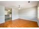 Open-concept living room with hardwood floors and views to the kitchen area at 1583 Rogers Crossing Dr, Lithonia, GA 30058