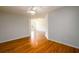 Open floor plan with hardwood flooring and neutral walls, providing a bright and airy living space at 1583 Rogers Crossing Dr, Lithonia, GA 30058