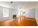 Spacious living room featuring hardwood floors, fireplace, and an open layout with adjacent rooms at 1583 Rogers Crossing Dr, Lithonia, GA 30058