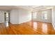 Spacious main bedroom with hardwood floors, tray ceiling with ceiling fan, and plenty of natural light at 1583 Rogers Crossing Dr, Lithonia, GA 30058