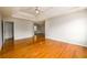 Spacious main bedroom with hardwood floors, tray ceiling with ceiling fan, and plenty of natural light at 1583 Rogers Crossing Dr, Lithonia, GA 30058