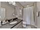 Well-lit bathroom featuring a single sink vanity, a toilet, a mirror, and a shower with curtain at 1839 Kent Ave, Atlanta, GA 30338