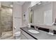 Modern bathroom featuring a glass-door shower and sleek vanity with a black countertop at 1839 Kent Ave, Atlanta, GA 30338