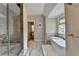 Elegant bathroom with a standalone tub next to a window and a glass enclosed shower at 1839 Kent Ave, Atlanta, GA 30338