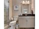 Neutral bathroom featuring a vanity with granite counters, toilet, and tiled walk-in shower at 1839 Kent Ave, Atlanta, GA 30338
