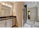 Bright bathroom featuring a vanity with countertop, large mirror, and glass-enclosed shower at 1839 Kent Ave, Atlanta, GA 30338