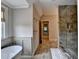 Bright bathroom displaying the tub, the enclosed glass shower, and towel racks at 1839 Kent Ave, Atlanta, GA 30338
