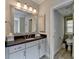 Well-lit bathroom featuring vanity with framed mirror and access to a seperate toilet area at 1839 Kent Ave, Atlanta, GA 30338
