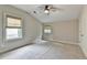 Bright bedroom with neutral walls, carpet, ceiling fan, and two windows with modern shades at 1839 Kent Ave, Atlanta, GA 30338
