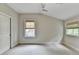 Bright bedroom with neutral walls, carpet, and two windows with modern shades at 1839 Kent Ave, Atlanta, GA 30338