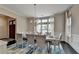 Formal dining room boasts a modern chandelier, large window, and neutral tones at 1839 Kent Ave, Atlanta, GA 30338