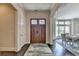 Inviting foyer with a wooden front door, hardwood floors, and views into the dining area at 1839 Kent Ave, Atlanta, GA 30338