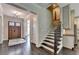 Inviting foyer with a wooden front door, staircase with dark wood treads, and hardwood floors at 1839 Kent Ave, Atlanta, GA 30338