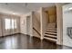 A hallway with hardwood floors, a staircase, and an open floorplan design at 1839 Kent Ave, Atlanta, GA 30338