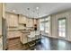 Beautiful kitchen featuring stainless appliances, an island with seating, pendant lights, and a door to the backyard at 1839 Kent Ave, Atlanta, GA 30338