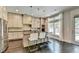 Stylish kitchen with stainless steel appliances, a large island with bar seating, and natural light at 1839 Kent Ave, Atlanta, GA 30338