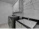 Laundry room with new washer and dryer, sink and overhead cabinets at 1839 Kent Ave, Atlanta, GA 30338