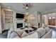 Bright living room features a fireplace, built-ins, large sectional, and many windows at 1839 Kent Ave, Atlanta, GA 30338