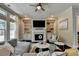 Bright living room features a fireplace, built-ins, large sectional, and many windows at 1839 Kent Ave, Atlanta, GA 30338