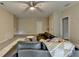 An open-concept living room featuring a ceiling fan, a sectional sofa, and a large area rug at 1839 Kent Ave, Atlanta, GA 30338