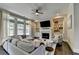 Bright living room features a fireplace, built-ins, large sectional, and many windows at 1839 Kent Ave, Atlanta, GA 30338