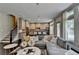 Open concept living room flowing into a modern kitchen featuring stainless steel appliances and ample natural light at 1839 Kent Ave, Atlanta, GA 30338