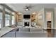 Bright living room features a fireplace, built-ins, large sectional, and many windows at 1839 Kent Ave, Atlanta, GA 30338