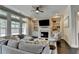 Bright living room features a fireplace, built-ins, large sectional, and many windows at 1839 Kent Ave, Atlanta, GA 30338