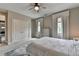 Cozy main bedroom features a ceiling fan, large closet, and two windows with soft, neutral decor at 1839 Kent Ave, Atlanta, GA 30338