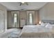 Comfortable main bedroom with large bed, ceiling fan, ensuite bath, and soft, neutral decor at 1839 Kent Ave, Atlanta, GA 30338