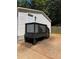 A charming dark painted back deck with matching railings and stairs provide a relaxing outdoor space at 320 White Birch Dr, Covington, GA 30016
