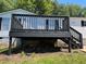 This home features a well-maintained back deck with dark painted railings, ideal for relaxing and entertaining at 320 White Birch Dr, Covington, GA 30016