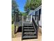 This home has a charming back deck painted in dark color with matching railings and steps at 320 White Birch Dr, Covington, GA 30016