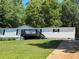 Charming home boasts a lush front yard and a spacious back deck perfect for outdoor entertaining at 320 White Birch Dr, Covington, GA 30016