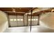 Unfinished basement with painted floor and two car garage doors offering the perfect space to personalize at 323 W Claiborne Ct, Marietta, GA 30066