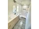 Modern bathroom featuring a double vanity, shower with marble tile, and updated lighting at 323 W Claiborne Ct, Marietta, GA 30066