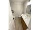 Cozy bathroom featuring a shower/tub, white vanity, toilet, and wood-look tile flooring at 323 W Claiborne Ct, Marietta, GA 30066