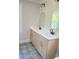 Modern bathroom with double vanity, quartz countertop, and arched mirrors and gold fixtures at 323 W Claiborne Ct, Marietta, GA 30066