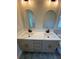 Modern bathroom with double vanity, quartz countertop, and arched mirrors and gold fixtures at 323 W Claiborne Ct, Marietta, GA 30066