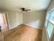 Bedroom with hardwood floors, ceiling fan, and a large window at 323 W Claiborne Ct, Marietta, GA 30066