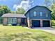 Beautiful two-story brick and blue home with a well-manicured front lawn and attached two-car garage at 323 W Claiborne Ct, Marietta, GA 30066